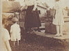 ruby-kelly-at-water-pump-muriel-beale-pouring-water-on-hog-with-ercile-looking-on-82280025