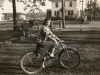 edith-chapman-on-bike-with-christopher-house-in-background-img063