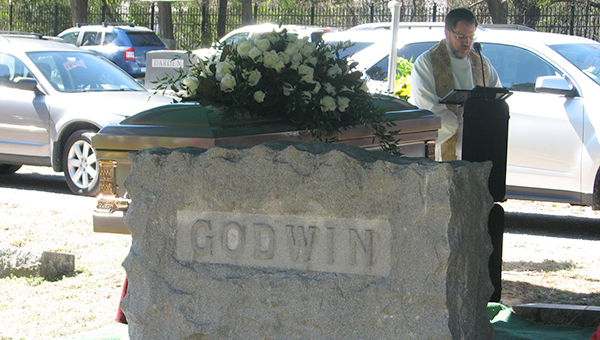 The Rev. Gregory Ryan of Oakland Christian United Church of Christ delivers words of comfort at the graveside service for Katherine Godwin on Friday at Cedar Hill Cemetery.